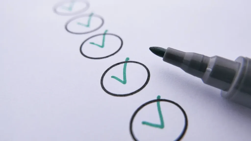 checkmarks on paper being marked with a pen
